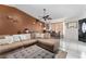 Inviting living room with tile flooring, a cozy sectional sofa, and ample natural light at 9911 Dean Cove Ln, Orlando, FL 32825