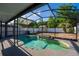 Sparkling pool with screened enclosure and mature landscaping at 9911 Dean Cove Ln, Orlando, FL 32825