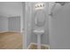 Half bathroom with pedestal sink, modern lighting, and neutral color scheme at 12928 Lexington Summit St, Orlando, FL 32828