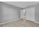 A room with closet, door, light gray walls, and wood floors at 12928 Lexington Summit St, Orlando, FL 32828