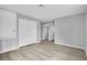 Spacious bedroom featuring light gray walls, wood-look flooring, and a double-door closet at 12928 Lexington Summit St, Orlando, FL 32828