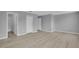 An airy bedroom showcasing gray walls, wood flooring, a closet, and attached bathroom at 12928 Lexington Summit St, Orlando, FL 32828