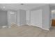 Open and airy bedroom with gray walls, light wood floors, and closet at 12928 Lexington Summit St, Orlando, FL 32828