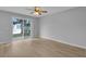 Bright bedroom with a ceiling fan and a sliding glass door offering tranquil water views at 12928 Lexington Summit St, Orlando, FL 32828