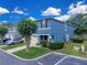 Side view of a blue townhome featuring green shrubbery and an adjacent parking space at 12928 Lexington Summit St, Orlando, FL 32828