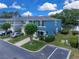 Eye-level aerial view of blue townhome and its proximity to nearby lake at 12928 Lexington Summit St, Orlando, FL 32828