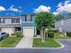 Charming blue townhome with a well-manicured lawn and attached one-car garage at 12928 Lexington Summit St, Orlando, FL 32828