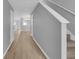 Bright hallway features neutral walls and flooring, leading to staircase and open living space at 12928 Lexington Summit St, Orlando, FL 32828
