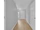 Light-filled entry hallway featuring new flooring, neutral paint, and access to other rooms at 12928 Lexington Summit St, Orlando, FL 32828