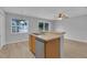Kitchen island with a sink overlooking the dining area and serene water views at 12928 Lexington Summit St, Orlando, FL 32828