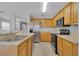 Well-equipped kitchen boasting stainless steel appliances and wood cabinets at 12928 Lexington Summit St, Orlando, FL 32828