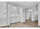 Laundry room featuring a washer, dryer, storage and wood look floors at 12928 Lexington Summit St, Orlando, FL 32828