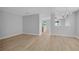 Spacious living room with neutral walls and updated flooring, featuring chandelier lighting at 12928 Lexington Summit St, Orlando, FL 32828