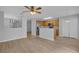 Open-concept living room and kitchen featuring modern finishes and stainless steel appliances at 12928 Lexington Summit St, Orlando, FL 32828