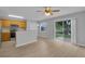 Open living space featuring stainless steel appliances, wood cabinets, and sliding glass doors to the outside at 12928 Lexington Summit St, Orlando, FL 32828