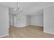 Open living area with new flooring and a modern light fixture, bright neutral paint, move-in ready at 12928 Lexington Summit St, Orlando, FL 32828