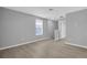 Spacious loft area with large window, neutral paint, and modern flooring at 12928 Lexington Summit St, Orlando, FL 32828