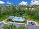 Aerial shot showcasing the community pool area with lounge chairs and lush greenery at 12928 Lexington Summit St, Orlando, FL 32828