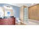 This bathroom features a vanity with a marble countertop and a separate bathtub/shower combo at 101 S Eola Dr # 812, Orlando, FL 32801