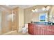 Bathroom featuring vanity with granite countertop, glass shower, and modern fixtures at 101 S Eola Dr # 812, Orlando, FL 32801
