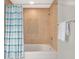 Bathroom featuring a bathtub and shower with tiled walls and a blue and white patterned curtain at 101 S Eola Dr # 812, Orlando, FL 32801