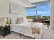 Bright bedroom with a queen bed and a desk with a view of the green landscape at 101 S Eola Dr # 812, Orlando, FL 32801