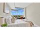 Bright bedroom with a queen bed and a desk with a view of the outdoor greenery at 101 S Eola Dr # 812, Orlando, FL 32801