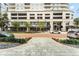 Exterior view of the building featuring street-side dining, classic brick-paved roads and an inviting entrance at 101 S Eola Dr # 812, Orlando, FL 32801