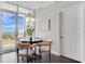 Cozy dining area with a modern chandelier, round table, and access to a balcony through large glass doors at 101 S Eola Dr # 812, Orlando, FL 32801