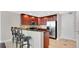 This open kitchen features dark wood cabinets, stainless steel appliances, and bar stool seating at 101 S Eola Dr # 812, Orlando, FL 32801