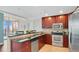 Cozy kitchen featuring dark wood cabinetry, stainless steel appliances, and granite countertops, perfect for cooking at 101 S Eola Dr # 812, Orlando, FL 32801