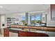 Modern kitchen with an eat-in counter and stainless steel dishwasher overlooking the living area and outdoor views at 101 S Eola Dr # 812, Orlando, FL 32801