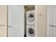 Efficient laundry area features a stacked washer and dryer, maximizing space at 101 S Eola Dr # 812, Orlando, FL 32801