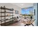 Bright living room with hardwood floors, a couch, shelving, and a balcony overlooking green outdoor views at 101 S Eola Dr # 812, Orlando, FL 32801