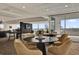 Spacious lounge area with comfortable seating and bar, with large windows overlooking city views at 101 S Eola Dr # 812, Orlando, FL 32801