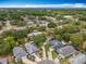An aerial view shows homes with solar panels and cul-de-sac, surrounded by lush greenery in a residential neighborhood at 10105 Dean Point Pl, Orlando, FL 32825