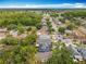 Aerial view of a well-maintained neighborhood with mature trees and nearby road for easy access to town at 10105 Dean Point Pl, Orlando, FL 32825