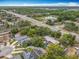 An aerial view of a neighborhood surrounded by lush trees with nearby highways and a lake at 10105 Dean Point Pl, Orlando, FL 32825