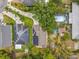 Aerial view of residential area with solar panels, pools, lush landscaping, and long driveways at 10105 Dean Point Pl, Orlando, FL 32825