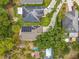 Aerial view of residential properties featuring solar panels, long driveways, and backyard pools at 10105 Dean Point Pl, Orlando, FL 32825