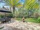 Cozy backyard with the patio table and brick layout with the fireplace at 10105 Dean Point Pl, Orlando, FL 32825