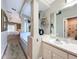 Bright bathroom with a soaking tub and a vanity with white cabinets and a modern mirror at 10105 Dean Point Pl, Orlando, FL 32825