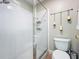 This is a clean bathroom with a glass shower and a toilet with wall decorations at 10105 Dean Point Pl, Orlando, FL 32825
