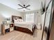 Spacious bedroom featuring a large bed, ceiling fan, with bright window and new floors at 10105 Dean Point Pl, Orlando, FL 32825