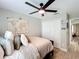 Cozy bedroom featuring light walls, a modern ceiling fan, and a decorative map for a personalized touch at 10105 Dean Point Pl, Orlando, FL 32825
