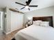This is a clean bedroom with white walls, new floor, ceiling fan, and nice bedding at 10105 Dean Point Pl, Orlando, FL 32825