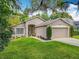 Charming single-story home featuring a well-manicured lawn and a two-car garage at 10105 Dean Point Pl, Orlando, FL 32825