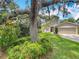 Attractive home with lush landscaping, a spacious lawn, and mature trees at 10105 Dean Point Pl, Orlando, FL 32825