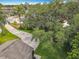 A large tree dominates the front lawn, shading the home; the driveway is long and leads to lush yard with palm trees at 10105 Dean Point Pl, Orlando, FL 32825