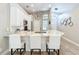 Charming kitchen with island seating, granite counters, white cabinets, and stainless steel appliances at 10105 Dean Point Pl, Orlando, FL 32825